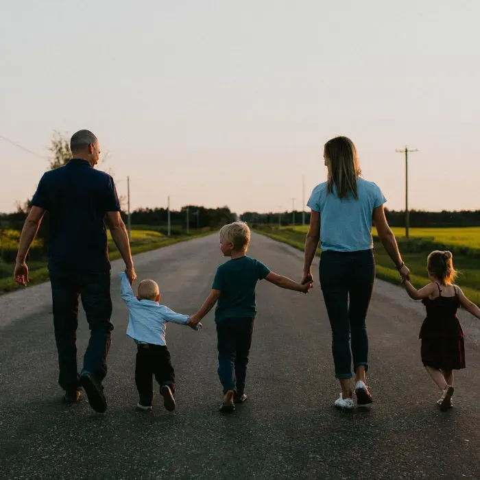 Lynn Dargis walking with her husband and their three children on the empty road.